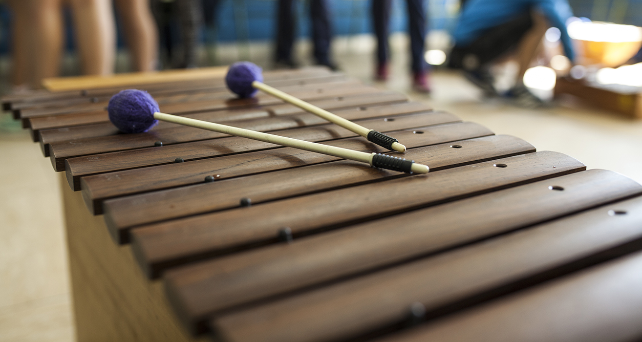 Two mallets rest on top of a xylophone.