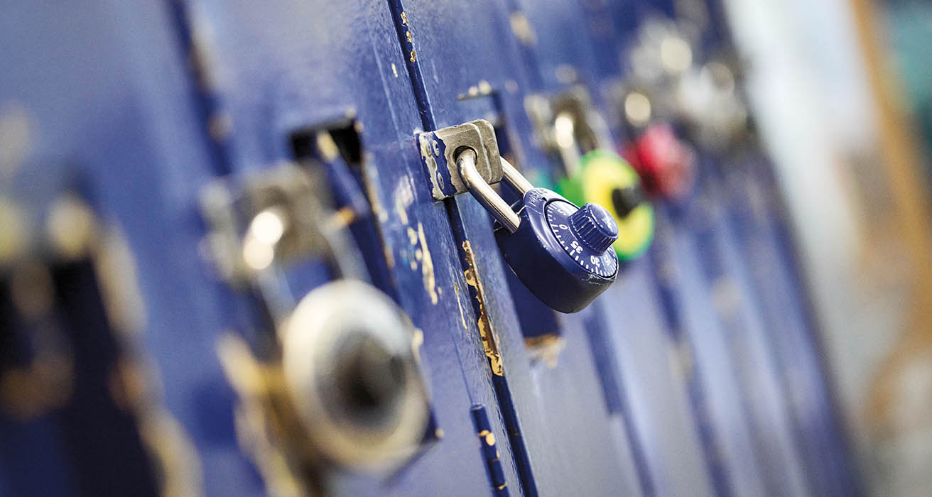 Colourful locks secure a row of school lockers.